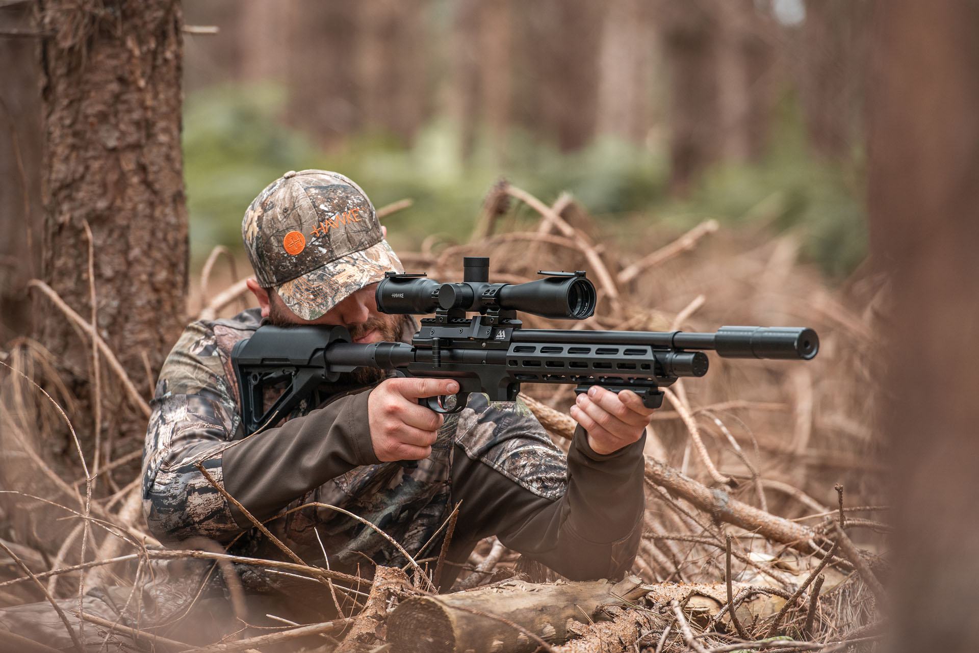 man with air rifle in field